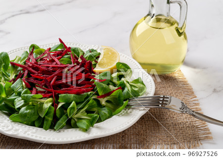 Lambs lettuce salad with raw beet closeup. 96927526