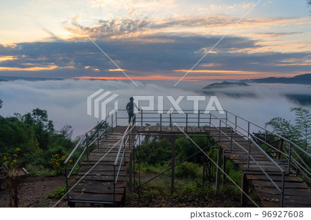 Traveler with the foggy landscape in Nong Khai province Thailand Traveler with the foggy landscape in Nong Khai province Thailand 96927608