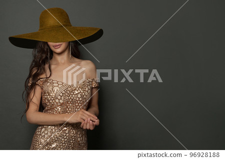 Cheerful fashionable woman fashion model wearing gold dress 96928188