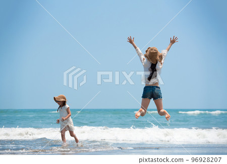 Parents and children playing in the sea Parents and children playing in the sea 96928207