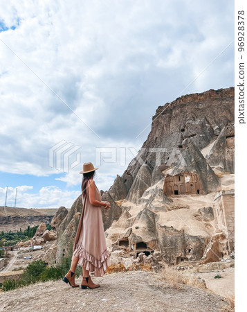 Young woman touring cave church in Cappadocia Young woman touring cave church in Cappadocia 96928378