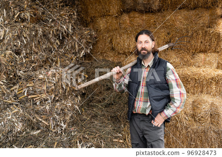 Bearded farmer in the hayloft. Bearded farmer in the hayloft. 96928473
