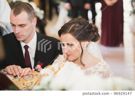 Married couple posing in a church after ceremony Married couple posing in a church after ceremony 96929147