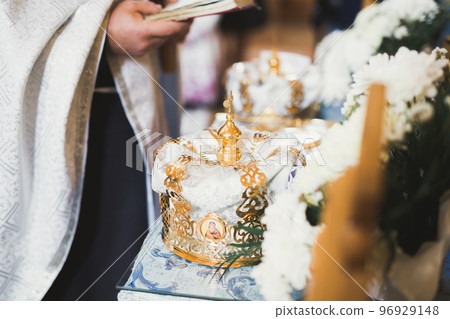 Golden crowns lying on the table in church Golden crowns lying on the table in church 96929148
