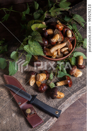 Pile of Imleria Badia or Boletus badius mushrooms commonly known as the bay bolete with knife on vintage wooden background.. Pile of Imleria Badia or Boletus badius mushrooms commonly known as the bay bolete with knife on vintage wooden background.. 96929218