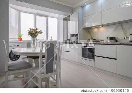 Interior of white modern kitchen with dining table Interior of white modern kitchen with dining table 96930146