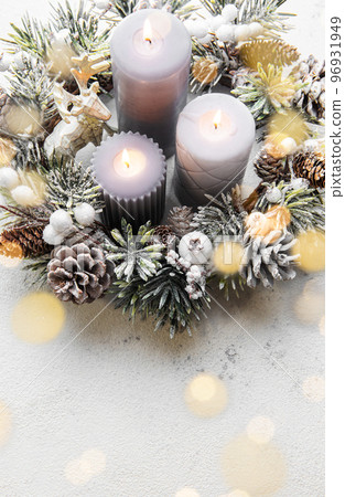 Decorated Advent wreath from fir and evergreen branches with burning candles, tradition in the time before Christmas. Decorated Advent wreath from fir and evergreen branches with burning candles, tradition in the time before Christmas. 96931949