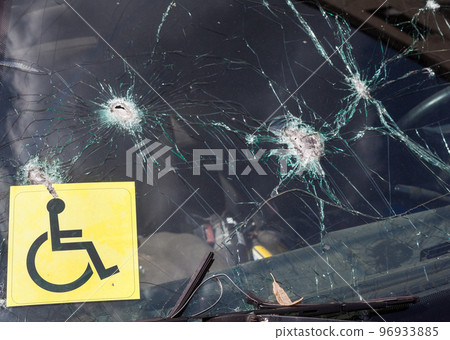 Bullet holes in the windshield of the car. Bullet holes in the windshield of the car. 96933885