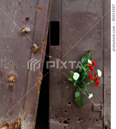 Bullet holes in the metal door of the residential building. Bullet holes in the metal door of the residential building. 96933887