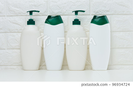 Empty plastic white bottles for cosmetics and other liquid substances on a white background. 96934724