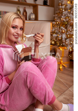 woman eating sushi, asian food restaurant, romantic evening, eating sushi with chopsticks, sushi delivery and takeout, eating at home, romantic dinner alone in christmas decor. Eve New year, saving woman eating sushi, asian food restaurant, romantic evening, eating sushi with chopsticks, sushi delivery and takeout, eating at home, romantic dinner alone in christmas decor. Eve New year, saving 96935349