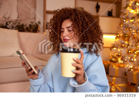 Young woman eating sushi at home. Home food delivery concept. Japan food. Top view. Space for text Young woman eating sushi at home. Home food delivery concept. Japan food. Top view. Space for text 96935359