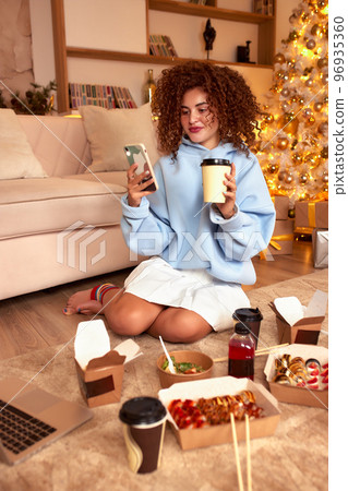 woman eating sushi, asian food restaurant, romantic evening, eating sushi with chopsticks, sushi delivery and takeout, eating at home, romantic dinner alone in christmas decor. Eve New year, saving woman eating sushi, asian food restaurant, romantic evening, eating sushi with chopsticks, sushi delivery and takeout, eating at home, romantic dinner alone in christmas decor. Eve New year, saving 96935360