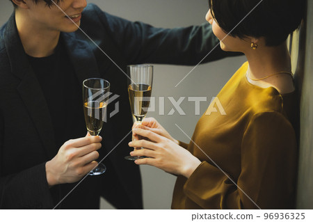 A couple toasting with champagne A couple toasting with champagne 96936325