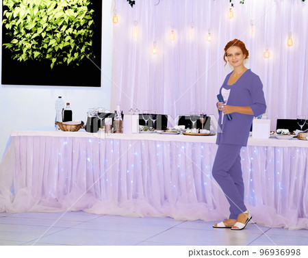 Host toastmaster near the festive table waiting of the newlyweds birthday quests 96936998