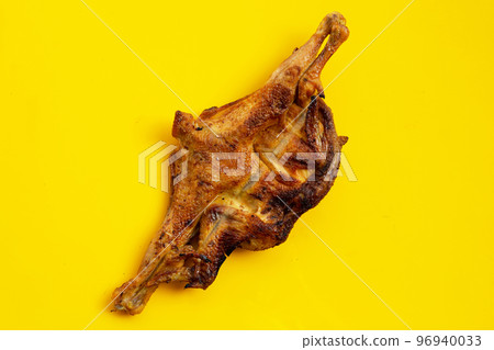 Grilled chicken, Thai style food on yellow background. Grilled chicken, Thai style food on yellow background. 96940033