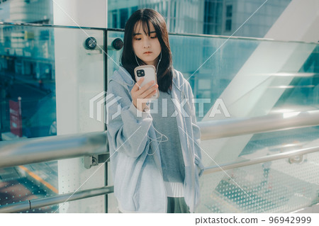 Photo with a high school girl and a smartphone in the city Photo with a high school girl and a smartphone in the city 96942999