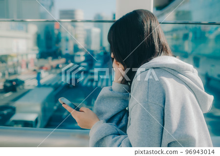 Photo with a high school girl and a smartphone in the city Photo with a high school girl and a smartphone in the city 96943014