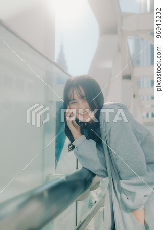 Photo with a high school girl and a smartphone in the city 96943232