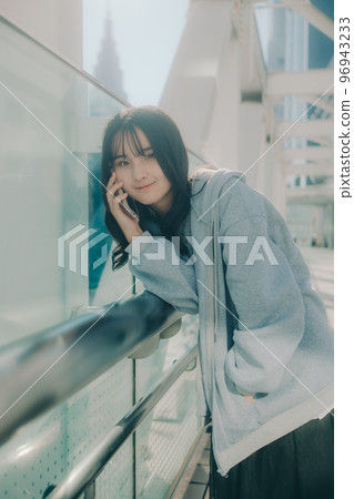 Photo with a high school girl and a smartphone in the city 96943233
