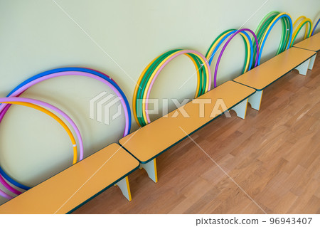 Yellow benches inside a school sports gym. Yellow benches inside a school sports gym. 96943407