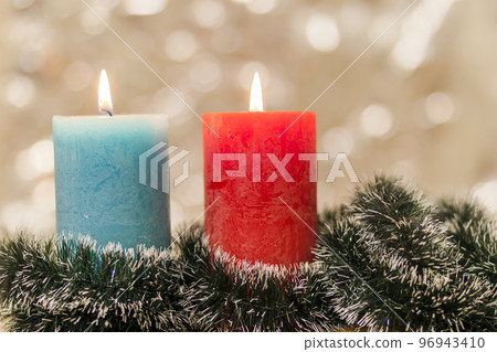 Yellow and blue colourful candles with blurred bokeh background. Christmas and New Year copy space. Yellow and blue colourful candles with blurred bokeh background. Christmas and New Year copy space. 96943410