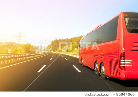 Tourist bus on asphalt freeway road in beautiful spring day at countryside Tourist bus on asphalt freeway road in beautiful spring day at countryside 96944066