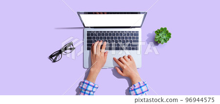Person using a laptop computer 96944575