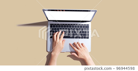 Person using a laptop computer 96944598
