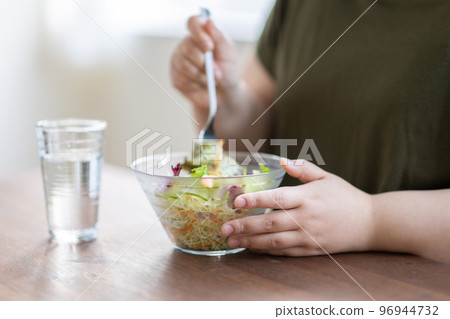 Woman eating salad Woman eating salad 96944732