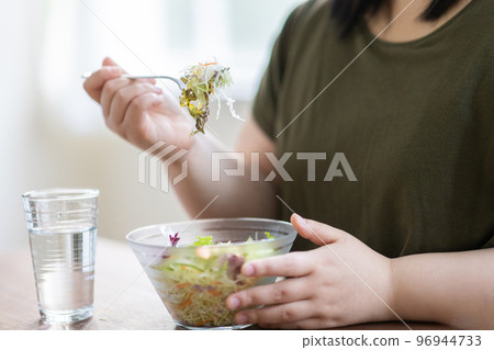 Woman eating salad Woman eating salad 96944733