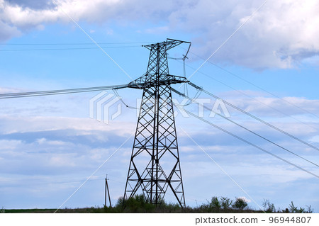 Steel pillar with high voltage electric power lines delivering electrical energy through cable wires on long distance 96944807