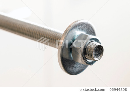Stainless steel bolts and nuts on a white background. Bolt, washer and nut on a white background. Bolt on a white background. Bolt screw nut washer carving. 96944808