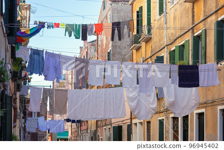 Laundry drying over an old narrow Venetian street. 96945402
