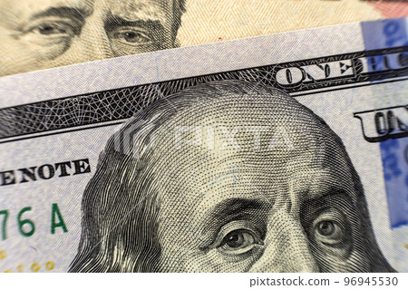 One hundred dollar bill detail with president Benjamin Franklin portrait close-up. American national currency banknote. Symbol of wealth and prosperity. Money, busyness and finances concept. 96945530