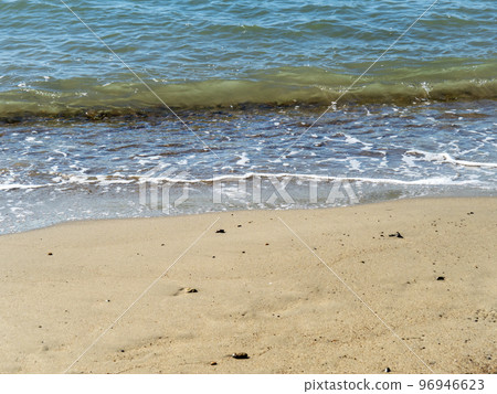 Waves on the sandy beach. 96946623