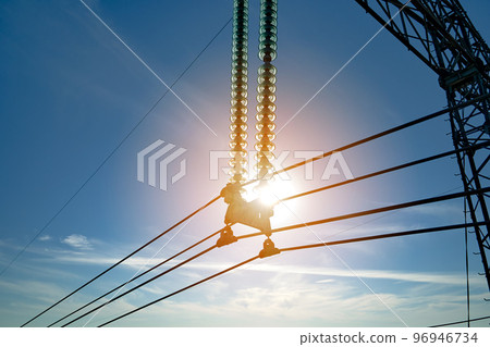 Electric power lines divided by safe guard insulating frame transfening safely high voltage electrical energy through cable wires. Electricity transmission on long distance concept Electric power lines divided by safe guard insulating frame transfening safely high voltage electrical energy through cable wires. Electricity transmission on long distance concept 96946734