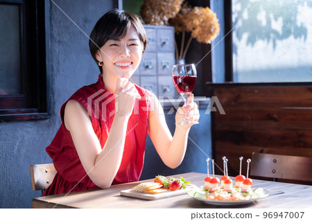 A woman drinking wine A woman drinking wine 96947007