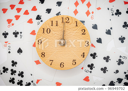 Playing cards and clock 12:00 96949702