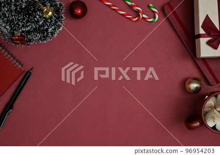 Top view, Red workspace in Christmas theme with copy space, Christmas tree, candies, notebooks 96954203