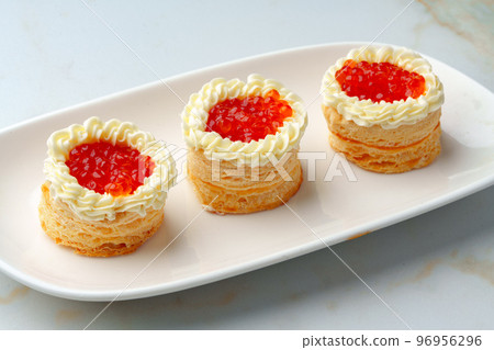 Red caviar in tartlets on white plate Red caviar in tartlets on white plate 96956296
