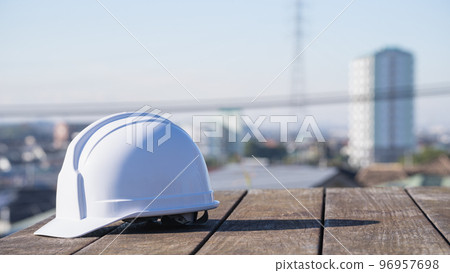 Helmet and cityscape | Construction industry / manufacturing industry image Helmet and cityscape | Construction industry / manufacturing industry image 96957698