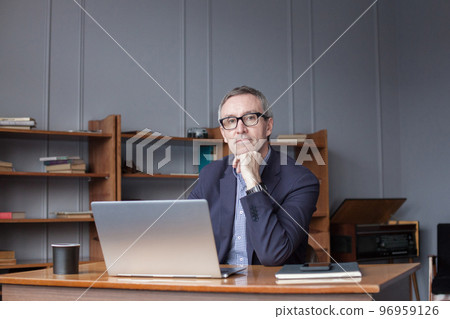 Business, people and technology concept. Mature businessman with laptop computer working at office 96959126