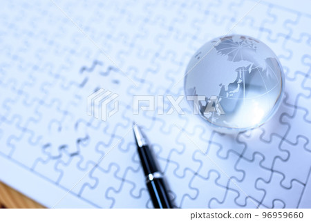 Globe on jigsaw puzzle last piece cold color Globe on jigsaw puzzle last piece cold color 96959660