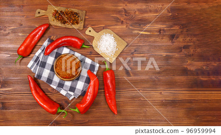 Ajvar from paprika, tomatoes, garlic and onions with spices on a brown wooden table. Balkan food. Copy space 96959994