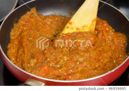Cooking spread called Ajvar from red peppers and eggplants. Selective focus Cooking spread called Ajvar from red peppers and eggplants. Selective focus 96959995