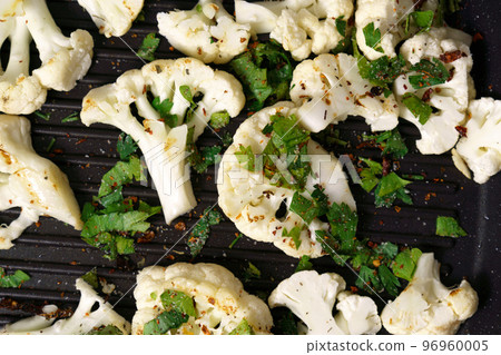 Cauliflower steaks cooking. Healthy eating, plant based meat substitute concept. 96960005