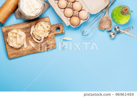 Cooking ingredients and utensils on blue background 96961489