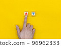 Hand pointing at up arrow block among up and down arrows 96962333
