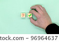The concept of choosing a question mark among question marks and check mark blocks 96964637